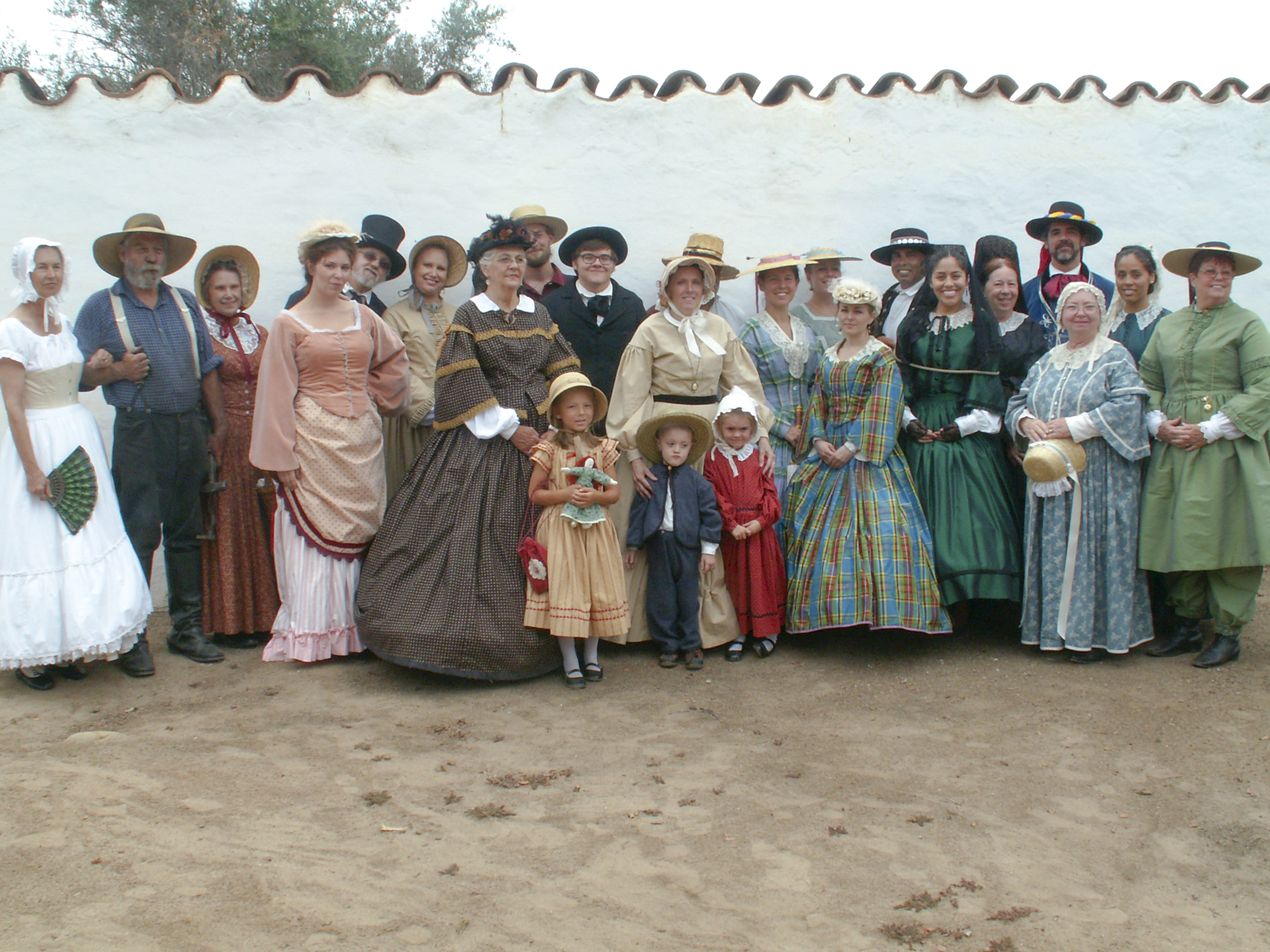 Photo of a group of people in various types of period attire ranging in date from 1821 through 1872
